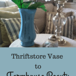 Beautiful farmhouse vase on a table with a candlestick , and glass bird.
